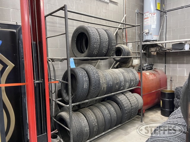 Tire rack & assorted used tires